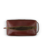 top view of A brown leather toiletry bag with a golden zipper, laying flat against a white background, showcasing its sleek design and quality craftsmanship.
