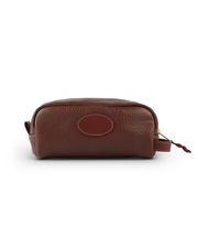 back view. A brown leather toiletry bag with a richly textured surface and a sturdy zipper, isolated on a white background. The bag features an oval-shaped patch that adds a distinctive design element, and its compact, rounded rectangular shape makes it an ideal travel accessory.