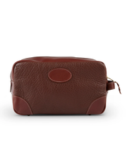 back view. A brown leather toiletry bag with a richly textured surface and smooth, darker brown accents, featuring a visible zipper, against a white background, exemplifying a blend of luxury and practicality.