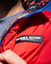 close up of left chest logo. black rectangle with white wording reading "bubba gump shrimp co."