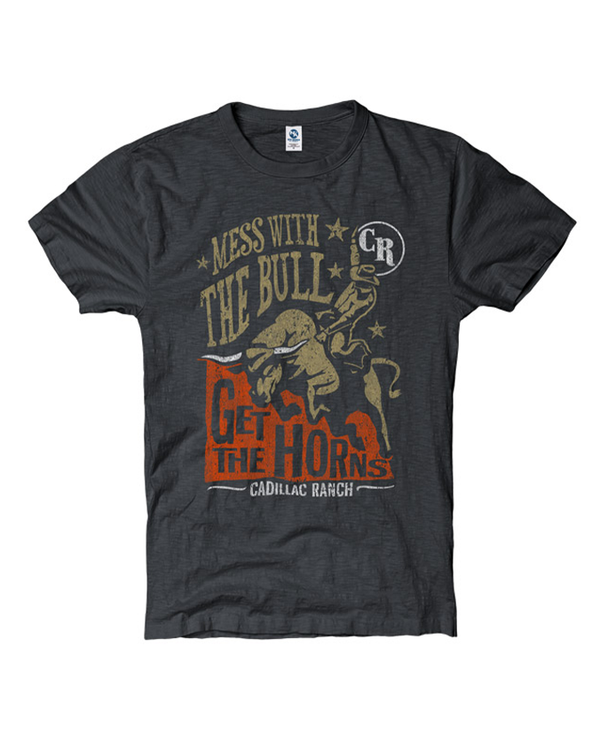 A dark gray crewneck T-shirt with a graphic on the front showing a cowboy riding a bull, and text reading: "MESS WITH THE BULL GET THE HORNS CADILLAC RANCH." A circular logo with the letters "CR" appears near the top right of the design. The background is plain white.