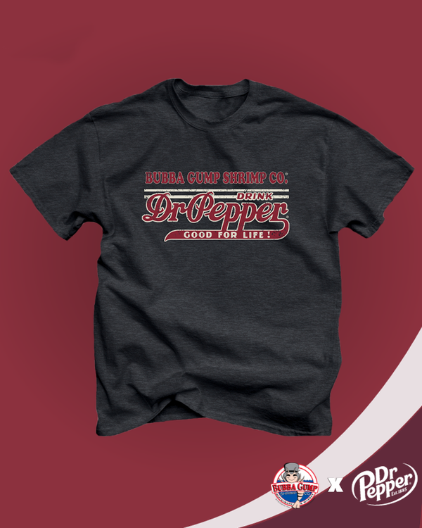 A grey crewneck t-shirt with linear details and "Bubba Gump Shrimp Co." and " DRINK DR PEPPER, GOOD FOR LIFE!" printed on it in a vintage style. The background is red with a white stripe and the Bubba Gump Shrimp X Dr. Pepper logos on the bottom corner.
