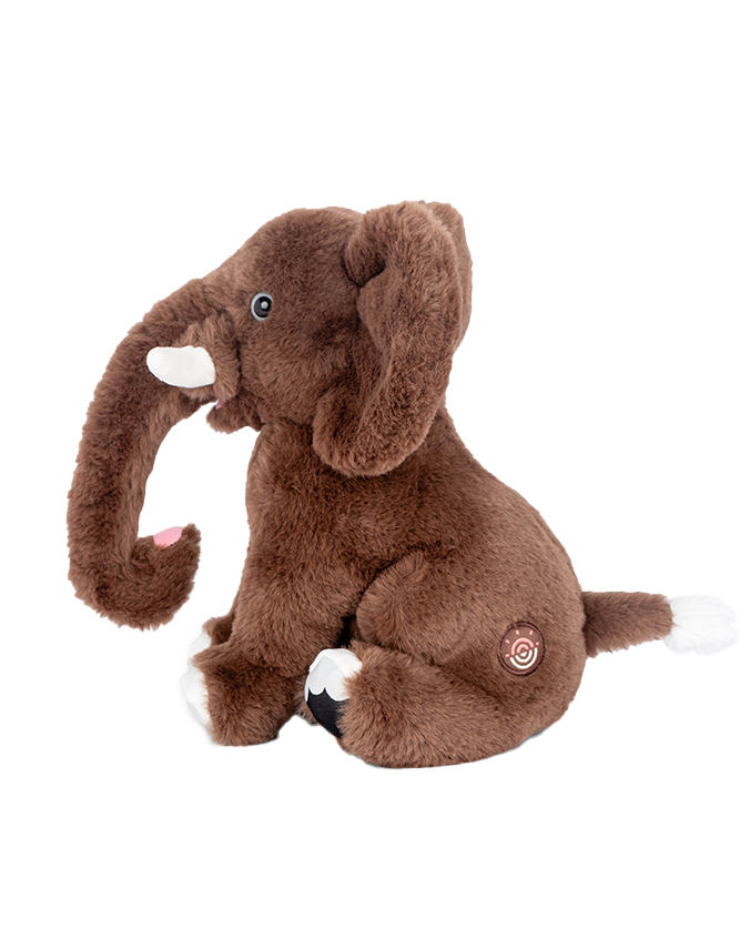 A sideview of a brown plush toy elephant sitting in front of a plain background, with a circular spiral patch on the backside.