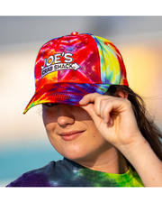 close up of female model wearing Vibrant tie-dye cap with Joe's Crab Shack branding in white.