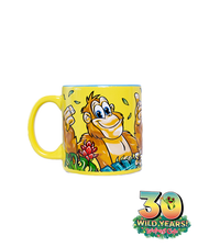 A cheerful yellow mug with a large handle, featuring a vibrant cartoon orangutang surrounded by green foliage and red flowers. The bottom of the image, logo celebrates ‘30 WILD YEARS! Rainforest Cafe’. The mug’s bright colors stand out against the white background.