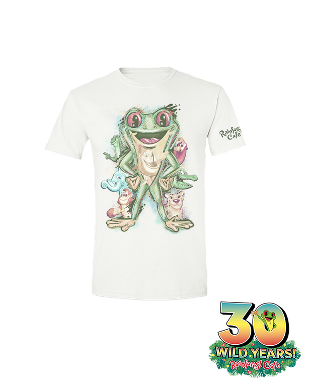 A white t-shirt with a vibrant illustration celebrating the 30th anniversary of Rainforest Cafe. The central figure is a large green frog, surrounded by various smaller animals. Below the design, the text reads ‘30 WILD YEARS! Rainforest Cafe’ with a tree frog sticking out the 0