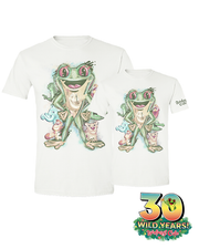 A small and large white t-shirt with a vibrant illustration celebrating the 30th anniversary of Rainforest Cafe. The central figure is a large green frog, surrounded by various smaller animals. Below the design, the text reads ‘30 WILD YEARS! Rainforest Cafe’ with a tree frog sticking out the 0.
