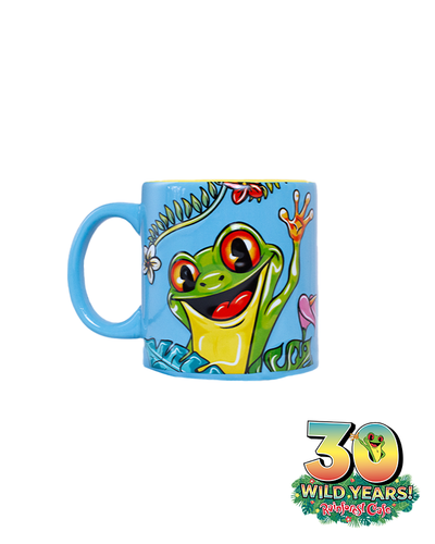 A blue mug with a handle on the left side, featuring an animated green frog with large, expressive eyes and an open mouth. The frog is surrounded by colorful tropical flowers and leaves, celebrating ‘30 WILD YEARS!’ at the Rainforest Cafe. Below the scene is the Rainforest Cafe logo with a smaller image of a green frog.
