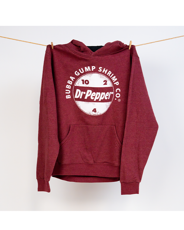 Burgundy hoodie with black drawstrings. In center chest, reads "bubba gump shrimp co." curved over the Dr Pepper circular logo. Hoodie is pined on a clothing line.
