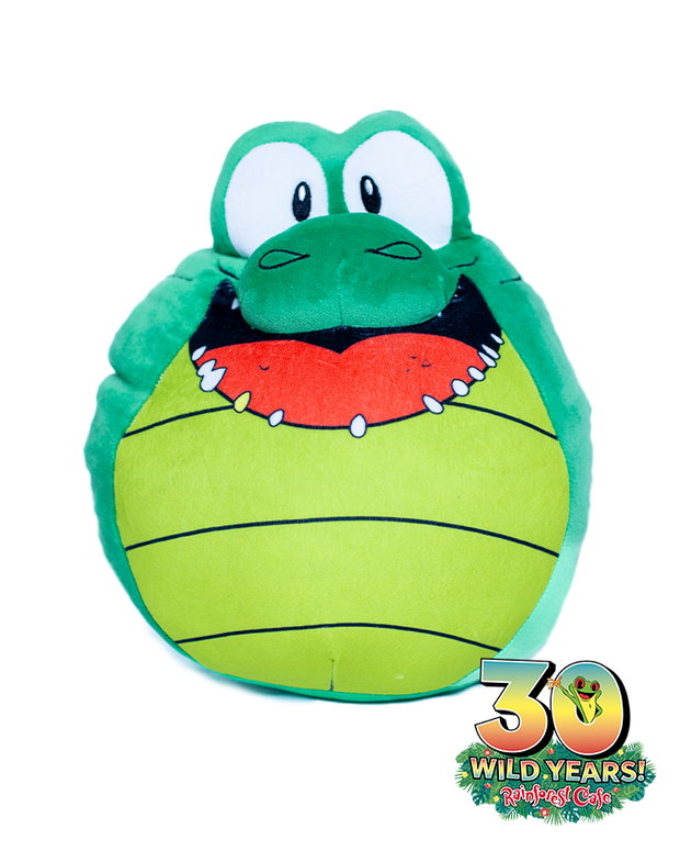 A plush toy depicting a whimsical green frog with a wide red mouth, big white eyes, and a yellow belly, celebrating ‘30 WILD YEARS!’ at the Rainforest Cafe.