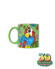 A colorful ceramic mug with a green handle, featuring a vibrant illustration of a red parrot with wings to beak. The mug is adorned with tropical flowers and leaves, and includes an emblem celebrating ‘30 WILD YEARS!’ of Rainforest Cafe with Cha Cha Sticking out the 0.