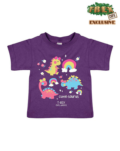 Purple tee with soft colors and cartoon dinosaurs, rainbows, flowers, and sparkles, as well as "Cutie-saurus" written at bottom.
