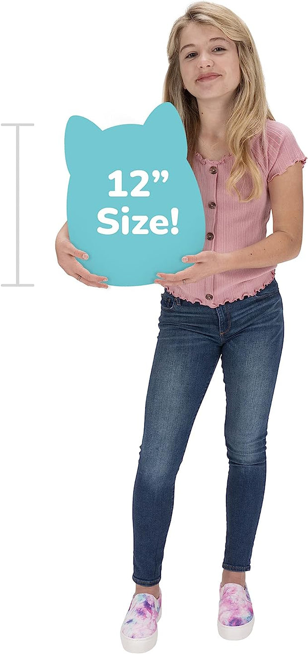 A girl in a pink top and blue jeans holds a large, blue cat-shaped sign that prominently displays ‘12” Size!’ while standing against a plain white background. Their colorful slip-on shoes add a playful touch to the ensemble.