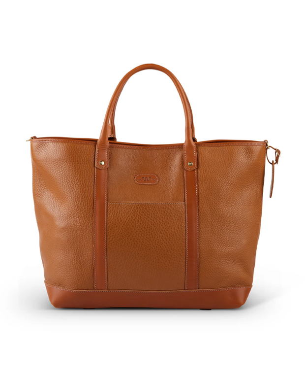 Front View. A spacious brown leather tote bag with a textured finish, featuring two robust handles and a subtle brand label, set against a pristine white background. The bag’s detailed stitching accentuates its elegant design, making it a versatile accessory for various occasions.