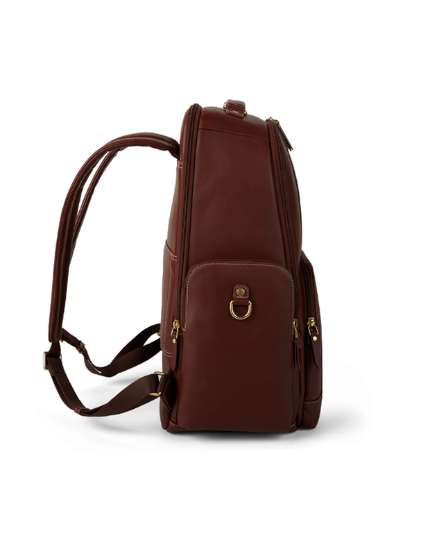 side view of A stylish brown leather backpack with multiple zippers and a front clasp, standing upright against a white background. The backpack features adjustable straps, quality stitching details, and a small handle for hand carrying, blending functionality with a sleek design.