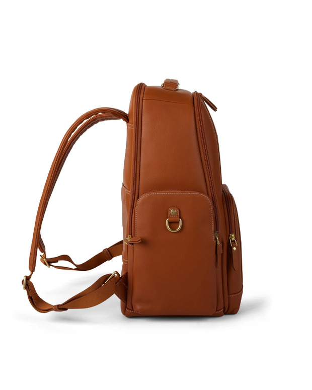 side view of A stylish light brown leather backpack with multiple zippers and a front clasp, standing upright against a white background. The backpack features adjustable straps, quality stitching details, and a small handle for hand carrying, blending functionality with a sleek design.