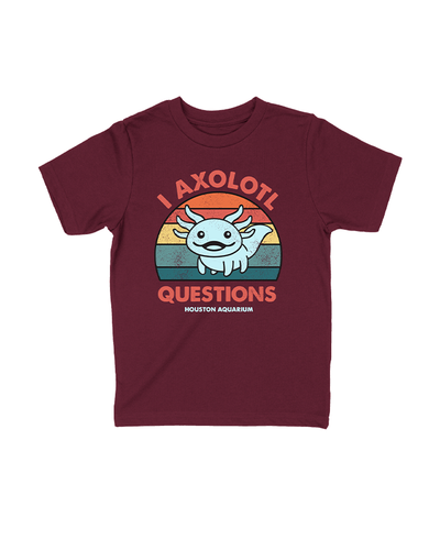 A maroon t-shirt featuring a cute axolotl illustration above the playful text ‘I AXOLOTL QUESTIONS’ and ‘HOUSTON AQUARIUM’ below, set against a retro-styled colorful striped background.”  The design on the shirt includes a smiling axolotl with gills, placed over a sunset-colored striped background. 