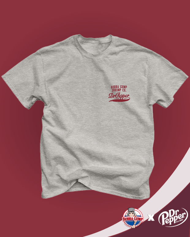 Dr. Pepper and Bubba Gump collaboration. Front view of grey t-shirt with text 'Bubba Gump Shrimp Co' and Dr. Pepper vintage logo in red. Shirt is on marron backdrop. 