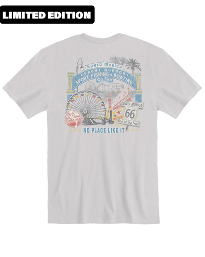 LIMITED EDITION text at the top of the image with A light grey t-shirt with a colorful graphic print showcasing Santa Monica’s iconic landmarks, including the Ferris wheel, palm trees, and Route 66 sign, accompanied by text highlighting the beach, harbor, sport fishing and boating.”
