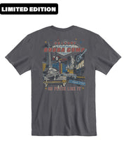 A gray t-shirt with a colorful graphic design on the back. The design features the words ‘LIMITED EDITION’ at the top in red, followed by a stylized depiction of a venue named ‘BUBBA GUMP SHRIMP CO’ with additional text ‘LOVE’ and ‘VEGAS STRIP’. The illustration includes city buildings, spotlights, and fireworks. At the bottom, it reads ‘NO PLACE LIKE IT’ in yellow letters. The overall theme suggests a special edition release related to the Bubba Gump Shrimp Company, possibly in connection to Las Vegas