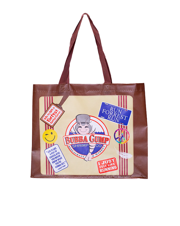 A tote bag with a beige center and brown edges featuring various printed designs and text. The central design is the ‘Bubba Gump Shrimp Co.’ logo with a shrimp illustration. Surrounding this are decorative elements including a smiling yellow face, a blue rectangle with ‘RUN FORREST RUN’ in white letters, a red tag stating ‘STOP FORREST STOP,’ and other assorted badges and slogans related to running. The bag’s theme appears to be inspired by the movie ‘Forrest Gump.