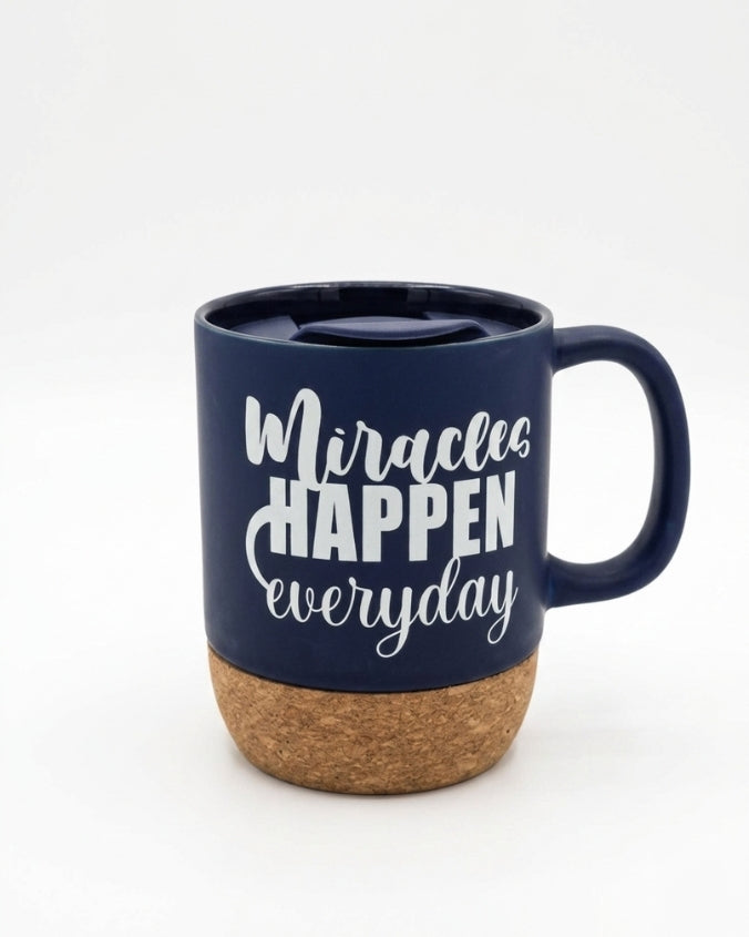 A navy blue ceramic mug with a cork base and a matching navy lid, featuring the white printed text 'Miracles HAPPEN everyday' on the front, set against a plain white background.