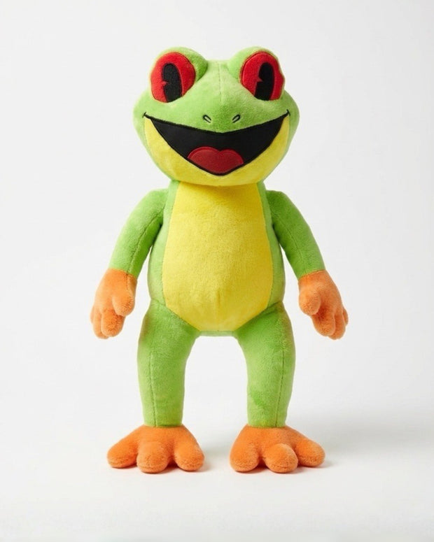 Plush frog toy with green body, orange feet and hands, and red eyes on a white background
