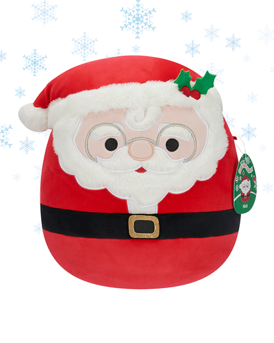 The image features a plush toy designed to resemble Santa Claus’ face, complete with a red hat, white beard, and glasses, against a background adorned with snowflakes. The plush has rosy cheeks, a fluffy white beard and mustache, and wears a red hat with holly leaves and berries.
