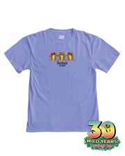 A light blue t-shirt with a colorful print featuring four frogs playing musical instruments. Above the print, the text ‘Rainforest Cafe’ is displayed. At the bottom, the ‘30 WILD YEARS! Rainforest Cafe’ logo is present, with a colorful frog face integrated in the zero. The t-shirt is laid flat against a white background.