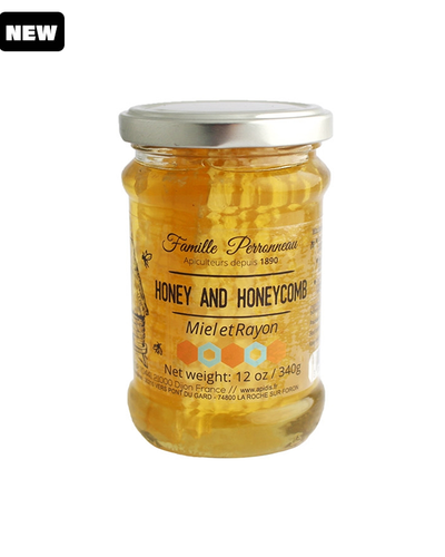 honey comb in a glass jar with silver top.