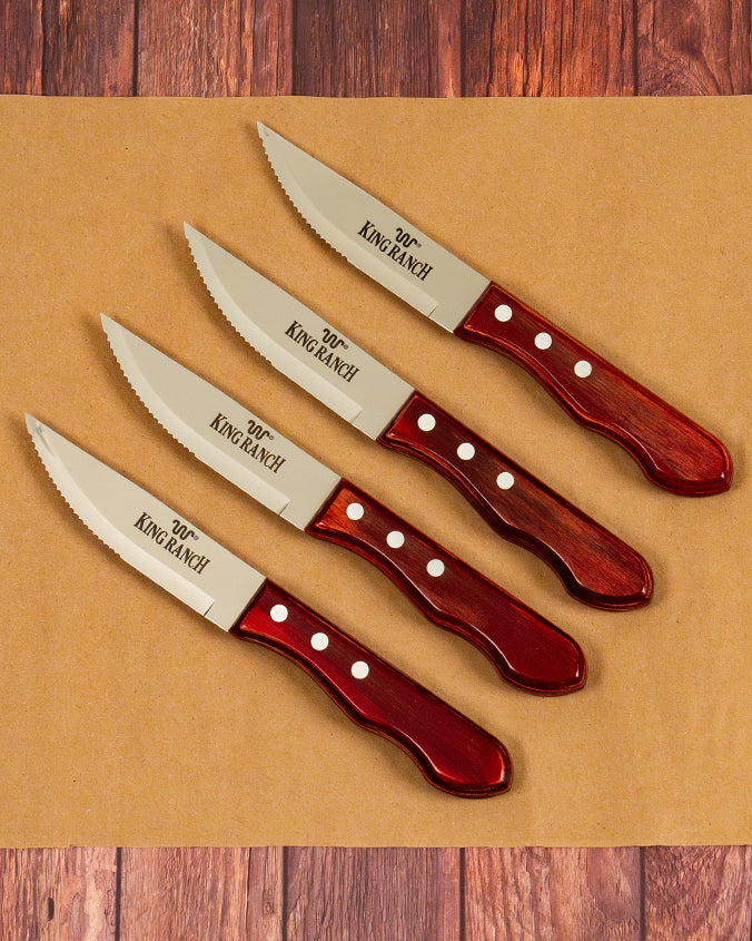 4 steak knives with King Ranch branding in front of wood background.