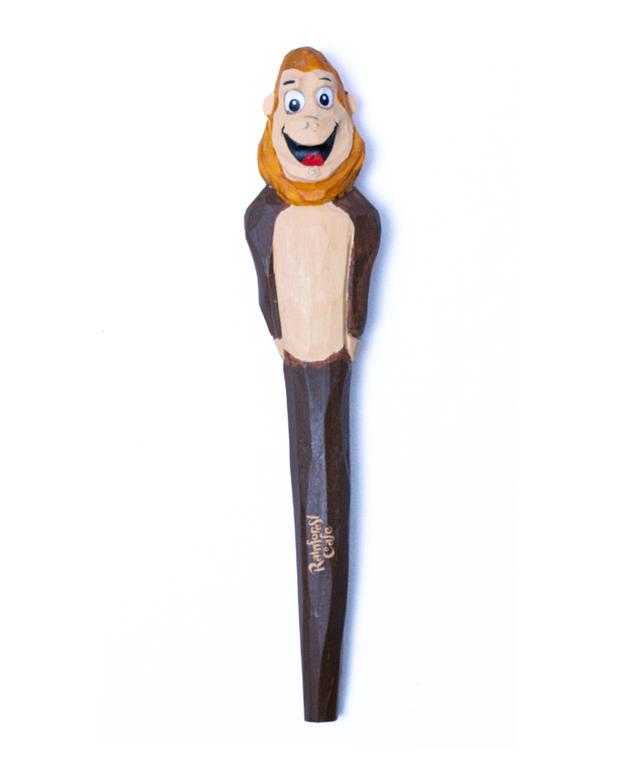 wood carved pen in shape of Bamba the Gorilla. top of pen is Bambas face, and the body on the rest of the pen in a brown color.