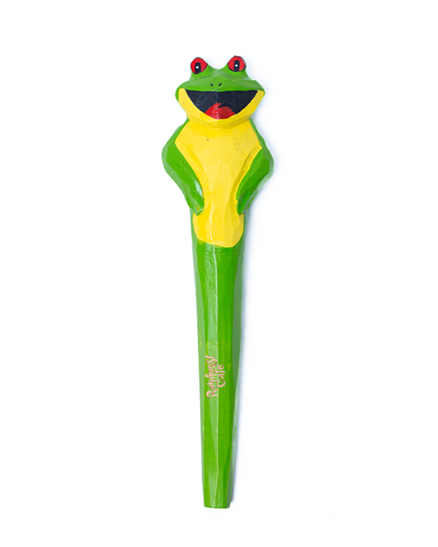 wood carved pen in shape of Cha Cha the Tree Frog. top of pen is Cha Cha's face, and the body on the rest of the pen in a greencolor.
