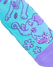 A close-up view of a vibrant turquoise sock, adorned with purple and blue elephant patterns and floral designs. The elephants are detailed with darker stitching and festive decorations, while the toe area is in solid purple, creating a striking contrast with the patterned body of the sock.