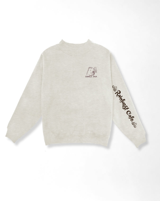 A light beige crewneck sweatshirt with a small graphic of capibara with a cup of coffee on the left chest and 'Rainforest Cafe' text printed in black along the right sleeve, shown against a plain white background.
