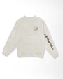 A light beige crewneck sweatshirt with a small graphic of capibara with a cup of coffee on the left chest and 'Rainforest Cafe' text printed in black along the right sleeve, shown against a plain white background.