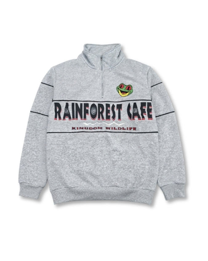 A heather gray quarter-zip sweatshirt featuring 'RAINFOREST CAFE' and 'KINGDOM WILDLIFE' printed across the chest, with a green and red frog logo on the left chest.