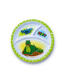 Children's plate with a Rainforest Cafe character iguana design on a white background