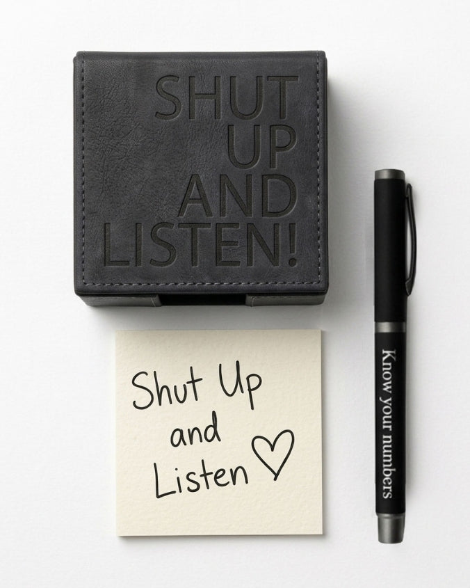 A black leather wallet with 'SHUT UP AND LISTEN!' embossed on the front, shown next to a cream sticky note that says 'Shut Up and Listen' and a black pen with 'Know your numbers.' printed on it, all arranged on a white background.