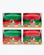 Four boxed pairs of Secret Santa holiday squishy dumplings on a white background. The packages contain either green or red dumplings, and each package has a clear plastic window with a colorful retail label reading 'Holiday Squishy Dumpling' and 'Which One Will You Get?'.