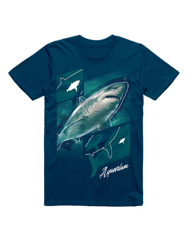 Blue tee shirt with a shark outlined. Overlapped of four squares, top left square has a shark silhouette and an outline over it. Bottom right has a shark silhouette. Bottom right reads "aquarium".