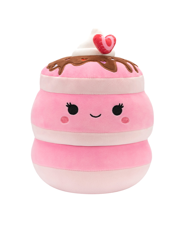 A plush toy designed as a pancake stack with a smiling face, chocolate icing, and a strawberry on top.
