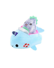 A plush toy featuring a light blue whale with a white underbelly, fins, and tail, adorned with red and white gill-like details. On top of the whale sits a smaller gray narwhal plush with a green tuft on its head, wearing a blue and white striped hat. The narwhal has small black eyes and pink cheeks, giving it a cute and whimsical appearance