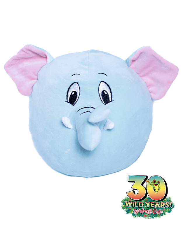 A plush toy with the face of a blue elephant, featuring large pink ears, expressive eyes, and a long trunk, with a logo at the bottom right of image that reads celebrating ‘30 WILD YEARS!’ of Rainforest Cafe with a tree frog coming out the zero.