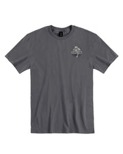 A plain gray t-shirt laid out flat against a white background. On the left chest area, there is a small circular logo or emblem with text and some design inside, but the details are not clear due to the size in the image. The t-shirt appears to be for adults.
