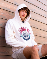 male model sitting on bench, back against wood wall. he is wearing Sweat Cream Heather pullover hoodie. Centered in a circle is the Bubba Gump Logo, above it reads "Bubba Gump". On the left is the number 19 and on the right is the number 75.