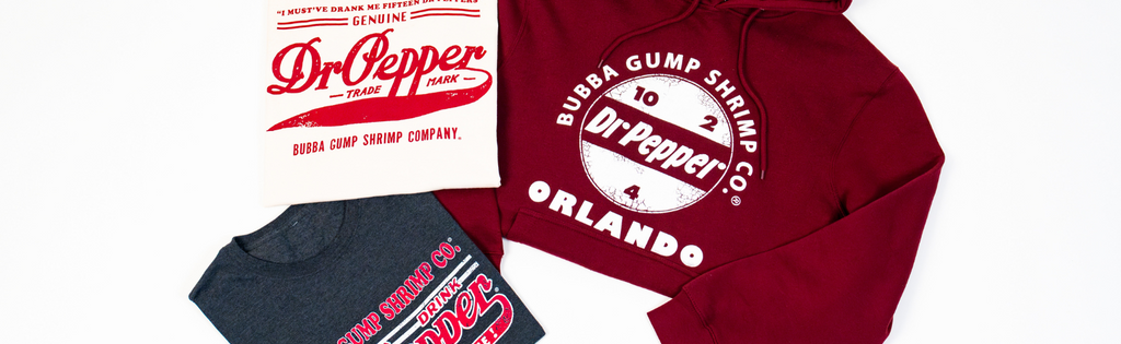 Three vintage-style apparel pieces: a white shirt with Dr. Pepper logo, a gray Bubba Gump shirt, and a red hoodie featuring both brands.