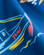 A close-up of blue fabric with a colorful design. The design includes abstract shapes and lines in yellow, red, white, and blue colors. The word "JENNY" is written in red text on a boat.