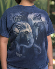 A blue t-shirt featuring a graphic print of two elephants with their trunks intertwined, set against the shirt’s darker blue fabric. Below the elephant design, the text ‘Rainforest Cafe’ is prominently displayed.