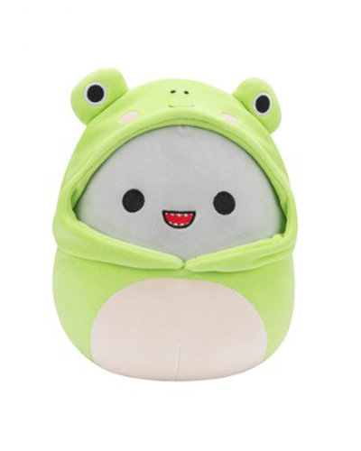 The image features a cute plush shark toy with a smiling face, wrapped in a green frog-themed hoodie with protruding eyes on top. The plush has a grey body with a wide smile, and the green hoodie gives it a playful frog-like appearance. 